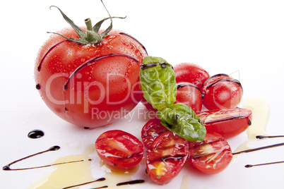 fresh red tomatoes with balsamic and oilve oil isolated