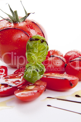 fresh red tomatoes with balsamic and oilve oil isolated