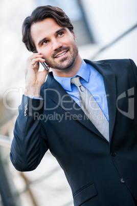 Businessman listening to a call on his mobile