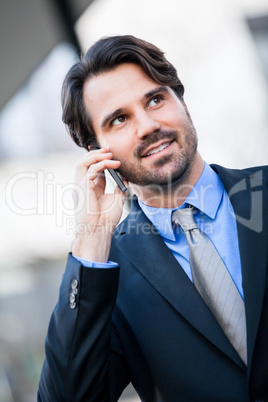 Businessman listening to a call on his mobile