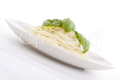 fresh delicious pasta with basil isolated on white