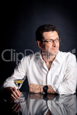 adult man holding an alcoholic drink
