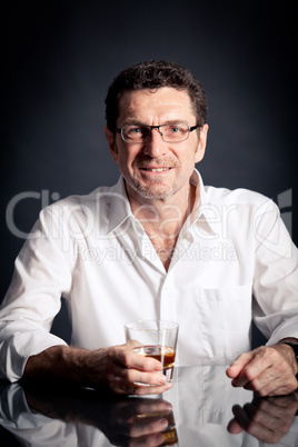 adult man holding an alcoholic drink