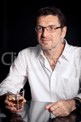 adult man holding an alcoholic drink