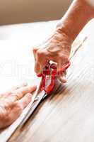 Hand Cutting Cloth with Scissors