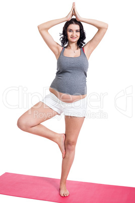 Active young pregnant woman doing yoga