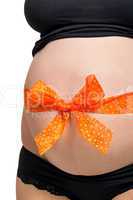 Pregnant woman wearing a bow on her belly