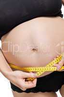 Pregnant woman measuring her abdomen