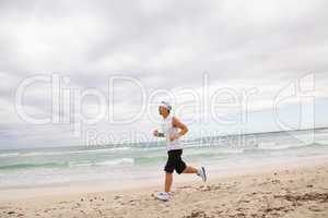 man is jogging on the beach summertime sport fitness