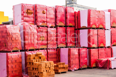 Red clay bricks stacked on pallets
