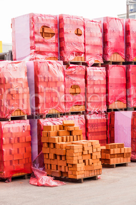 Red clay bricks stacked on pallets