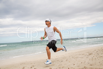 man is jogging on the beach summertime sport fitness