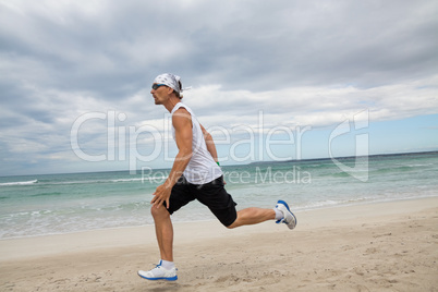 man is jogging on the beach summertime sport fitness