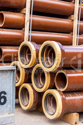 Several pipes stacked in yard