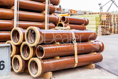 Several pipes stacked in yard