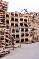 Stacks of old wooden pallets in a yard