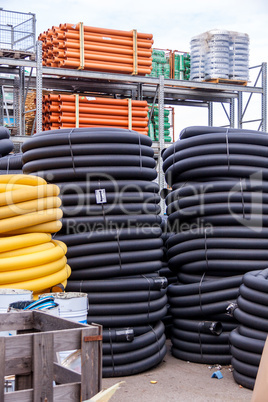 Rolls of plastic pipes in a warehouse yard