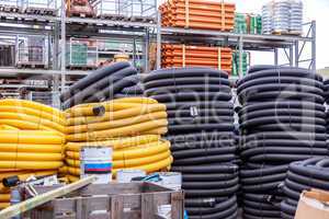 Rolls of plastic pipes in a warehouse yard