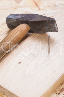 Mallet with nails and planks of new wood