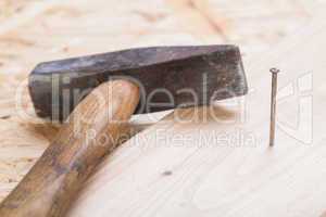 Mallet with nails and planks of new wood