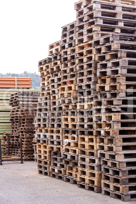 Stacks of old wooden pallets in a yard