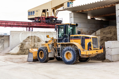 Parked pay loader near pile of dirt