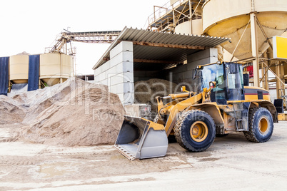 Parked pay loader near pile of dirt