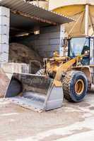 Parked pay loader near pile of dirt