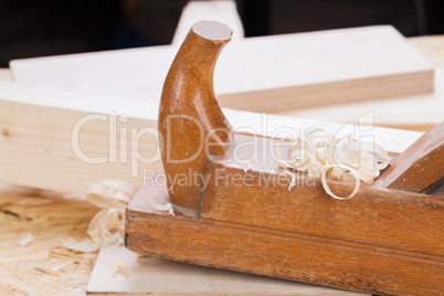 Handheld wood plane with wood shavings
