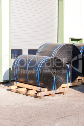 Rolls of black industrial plastic