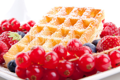 sweet fresh tasty waffles with mixed fruits isolated