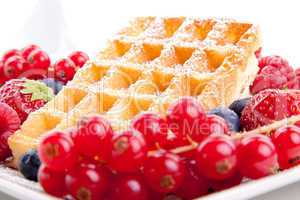 sweet fresh tasty waffles with mixed fruits isolated