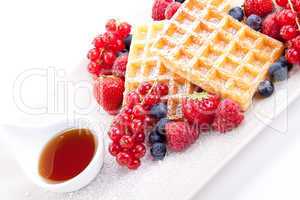 sweet fresh tasty waffles with mixed fruits isolated