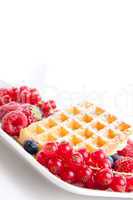 sweet fresh tasty waffles with mixed fruits isolated