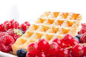 sweet fresh tasty waffles with mixed fruits isolated