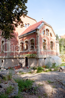 big old red building house with garden