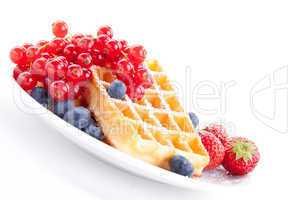 sweet fresh tasty waffles with mixed fruits isolated