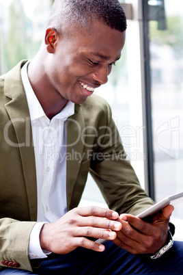 smiling successful businessman with tablet pc outdoor