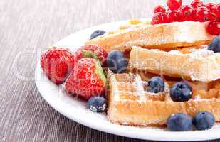 sweet fresh tasty waffles with mixed fruits isolated