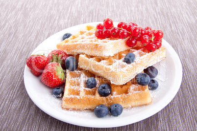 sweet fresh tasty waffles with mixed fruits isolated