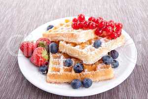 sweet fresh tasty waffles with mixed fruits isolated