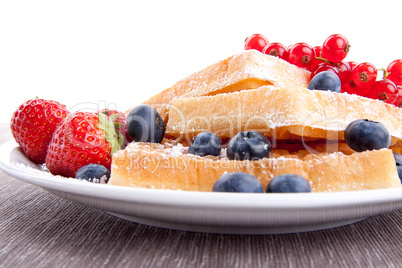 sweet fresh tasty waffles with mixed fruits isolated