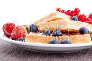 sweet fresh tasty waffles with mixed fruits isolated