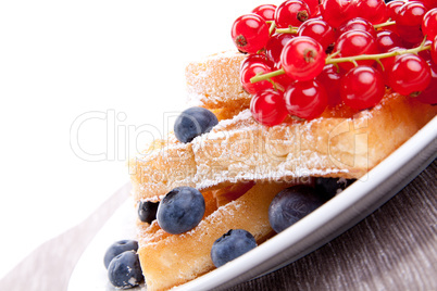 sweet fresh tasty waffles with mixed fruits isolated