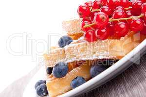 sweet fresh tasty waffles with mixed fruits isolated