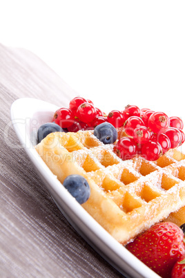 sweet fresh tasty waffles with mixed fruits isolated