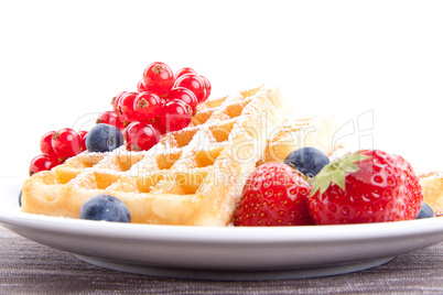 sweet fresh tasty waffles with mixed fruits isolated