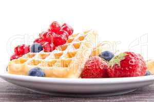 sweet fresh tasty waffles with mixed fruits isolated