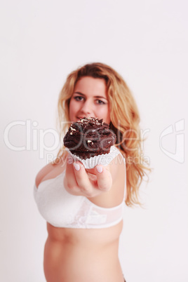 Frau  präsentiert einen Muffin aus Schokolade