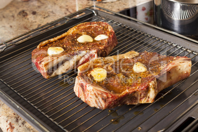 Two Steaks Marinated with Oil and Garlic on Grill